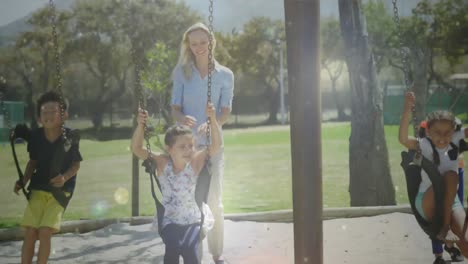 Mother-playing-with-her-child-on-the-swing