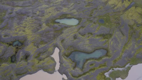 aerial top down shot of glacial lakes and rivers on iceland during cloudy day