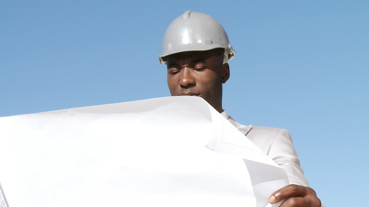 Responsible architect looking at a blueprint plan