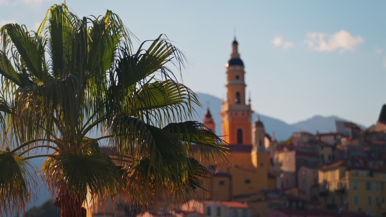 Distant view of the St Michel Basilica surrounded by colourful buildings, Menton, France