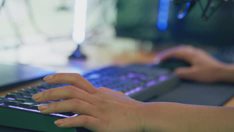 Close-Up-Of-Female-Gamer-Using-Computer-Keyboard-And-Mouse-For-Live-Stream