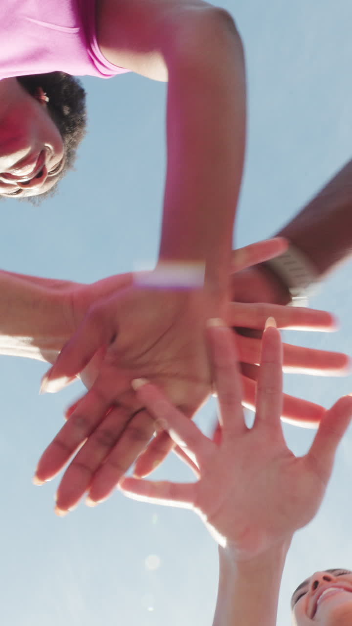 Diverse Group of Friends Stacking Hands Together in a Huddle