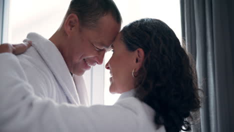 Couple embracing in bathrobes