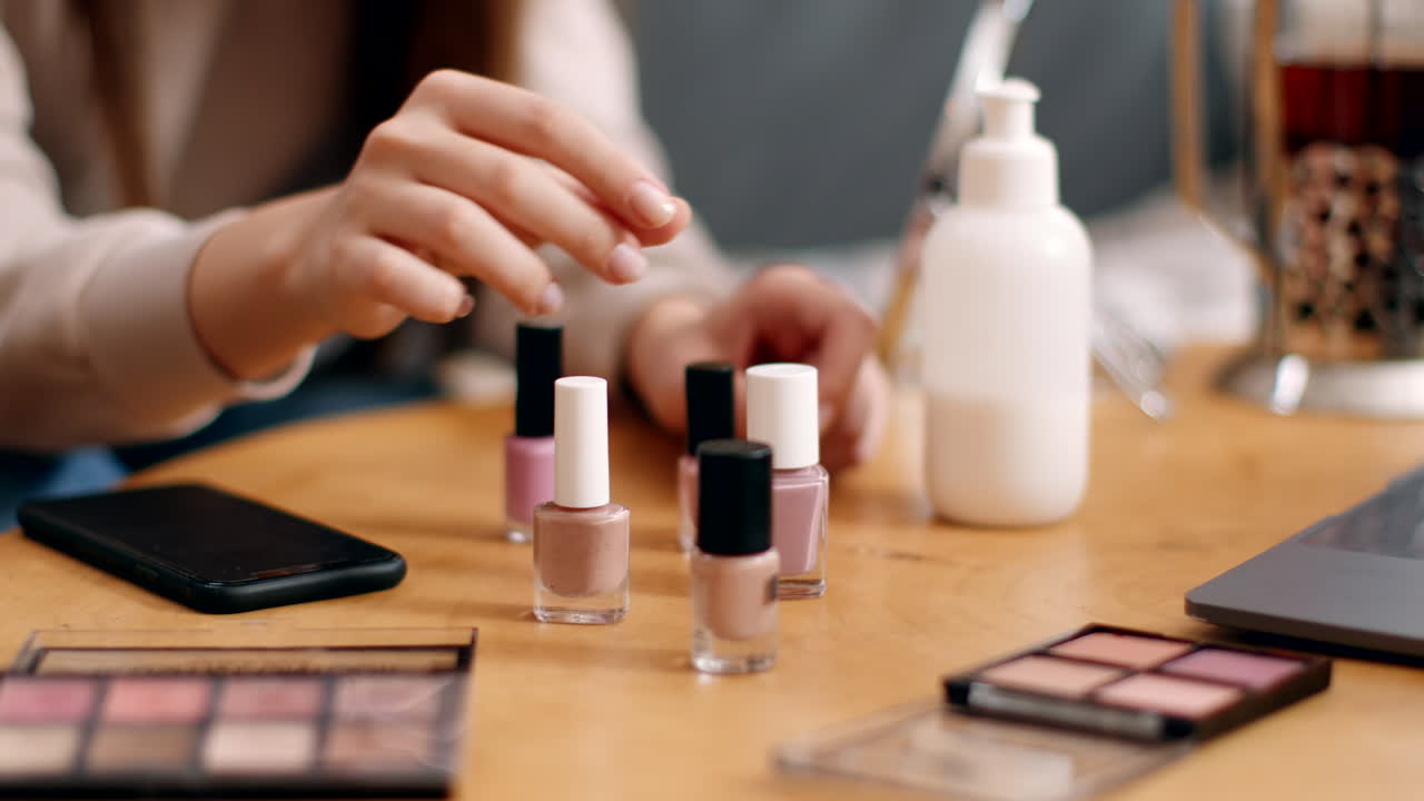 Woman applying nail polish at a home office desk