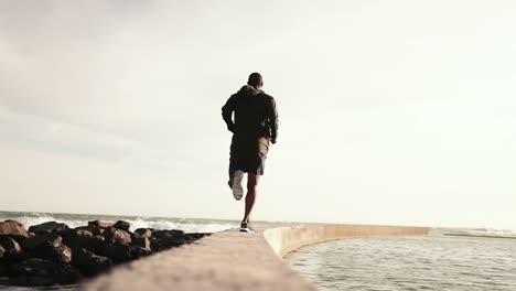 hombre corriendo por el paseo marítimo