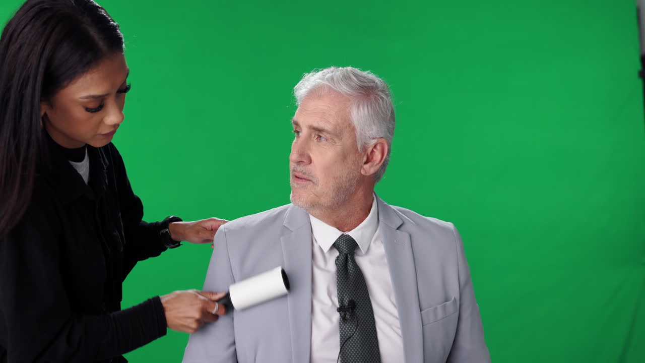 Man in suit in front of green screen