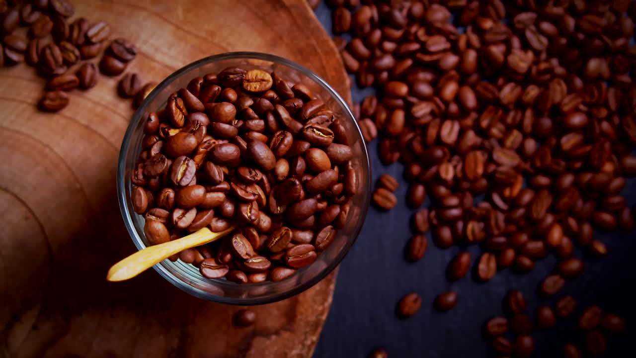 Stop-motion journey of coffee beans transforming into a freshly brewed cup topped with creamy foam. Stirring spoon add a dynamic touch. Perfect for coffee shops, advertising and social media. Flat lay