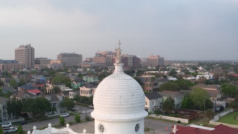 drone view of statue on top of the sacred heart catholic church in galveston, texas