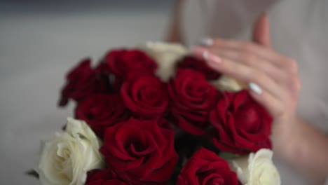 wedding bouquet of red roses in the hands of the bride