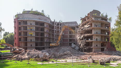 timelapse of industrial heavy machinery demolishing an obsolete building