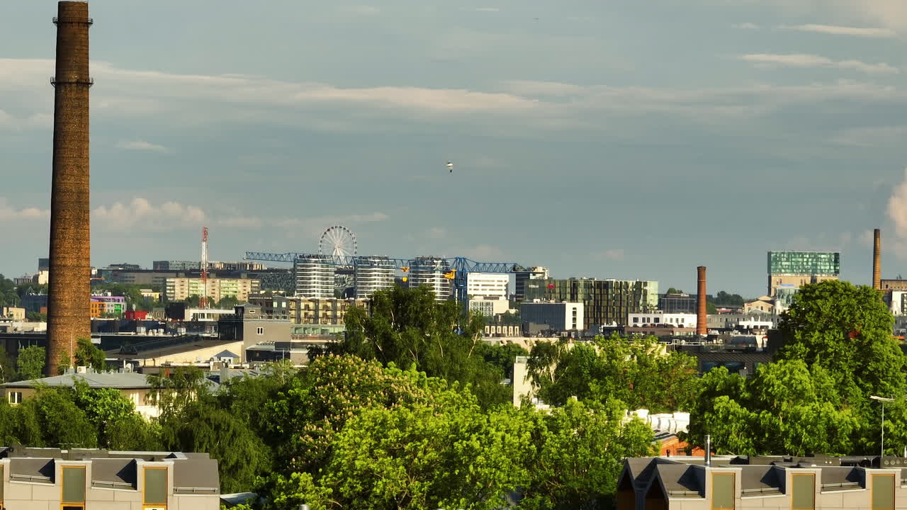 Telephoto drone shot of the cityscape of Tallinn city, summer day in Estonia