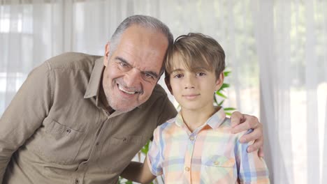 Smiling-grandfather-and-grandchild-who-looks-at-camera.