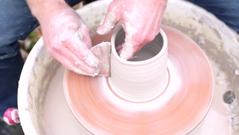 man throwing a pottery mug made of clay