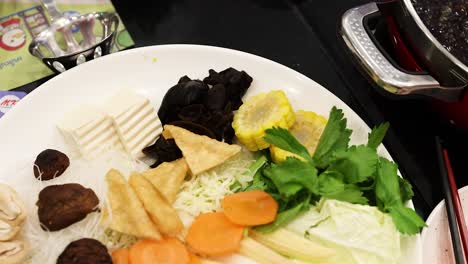 preparing hotpot with fresh ingredients in bangkok