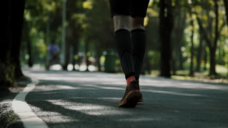 Crowd-of-urban-population-enjoying-early-morning-walk,-exercising-and-riding-bicycle-early-in-park-during-the-weekend-break-recreational-activities