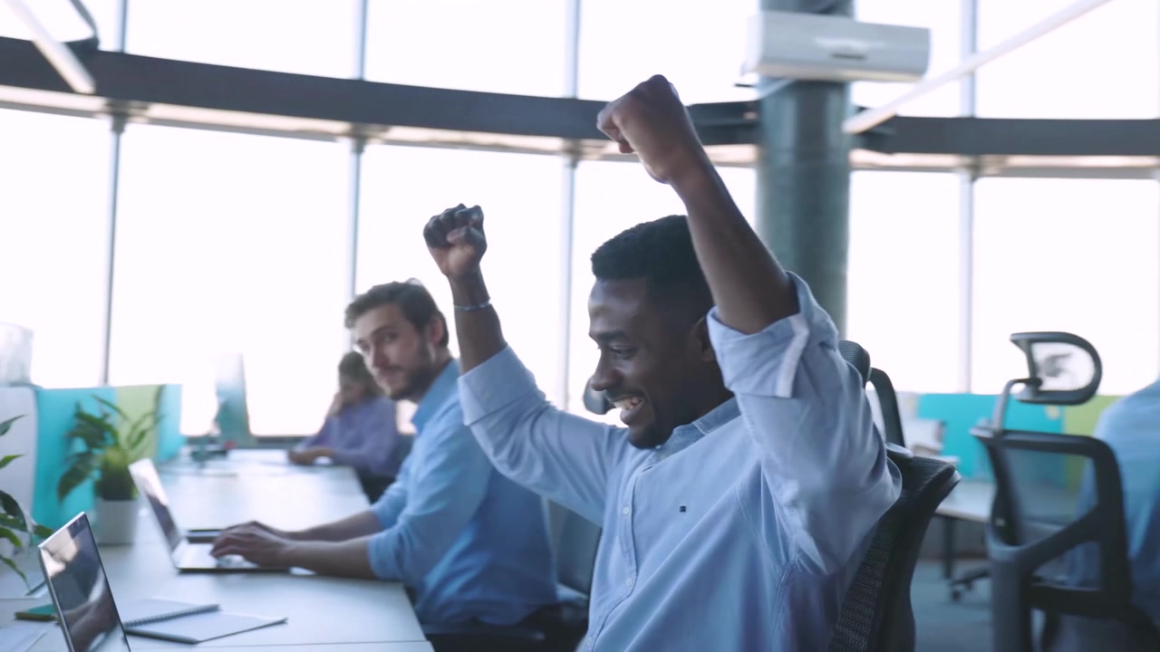 African American Businessman Celebrating Success in Modern Office