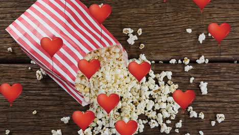 animation of heart icons over box of popcorn