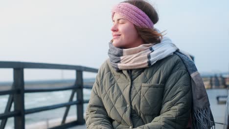 woman reading a book on a pier in winter