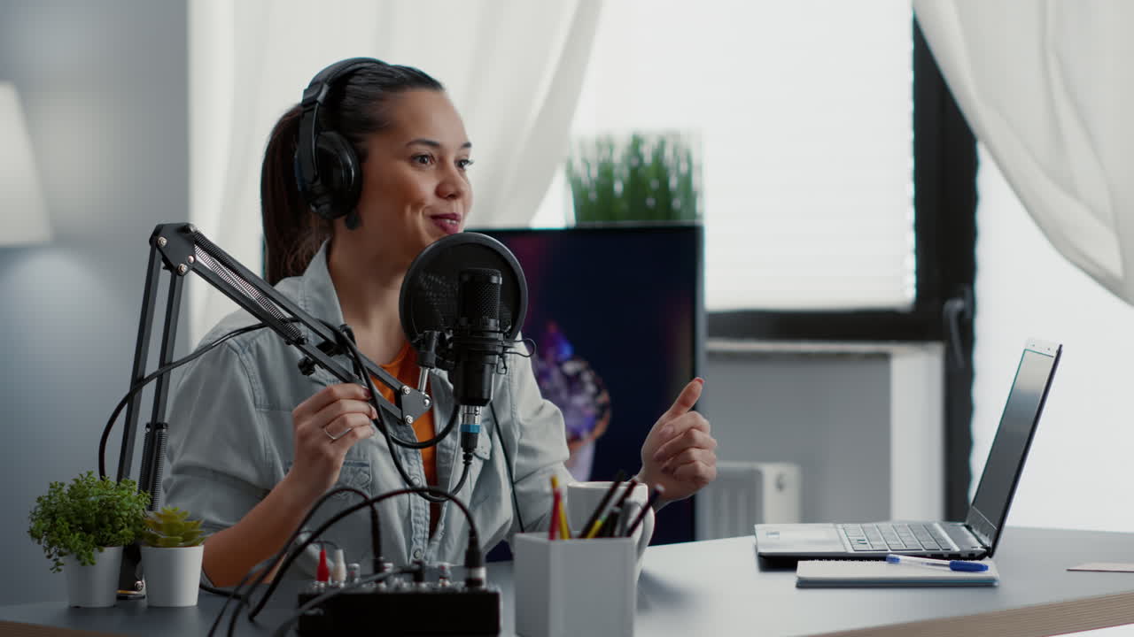 Creative content creator recording vlog in home studio while tweaking knobs on audio mixer