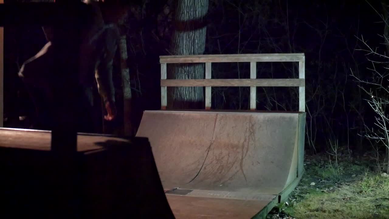 skateboarding notturno su una mini rampa nel cortile sul retro