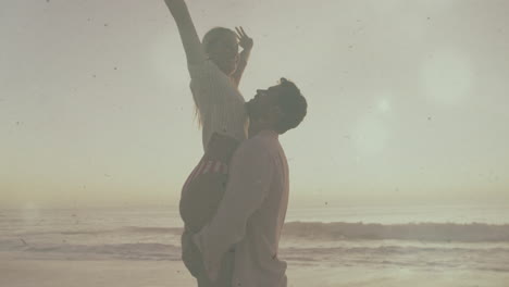 man lifting woman at sandy beach during sunset, with floating wave icons for travel marketing