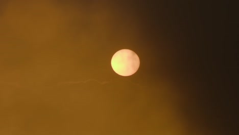 sunrise/sunset through hazy clouds