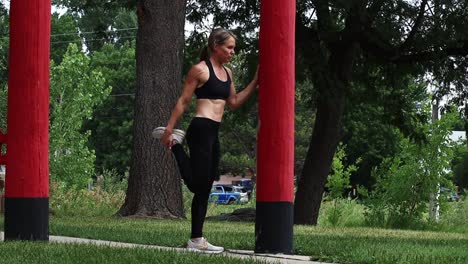 a woman stretches before her run. limber and lengthen muscles