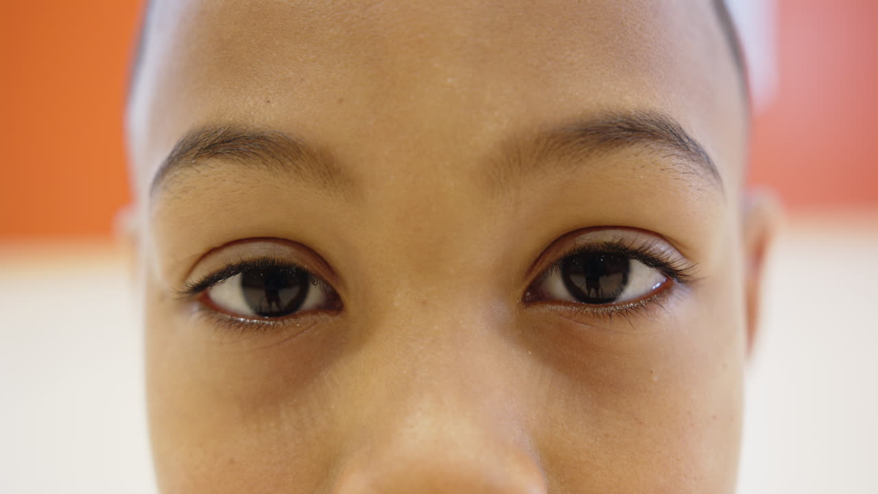 Close-up of child's eyes, focusing and looking attentively in school setting