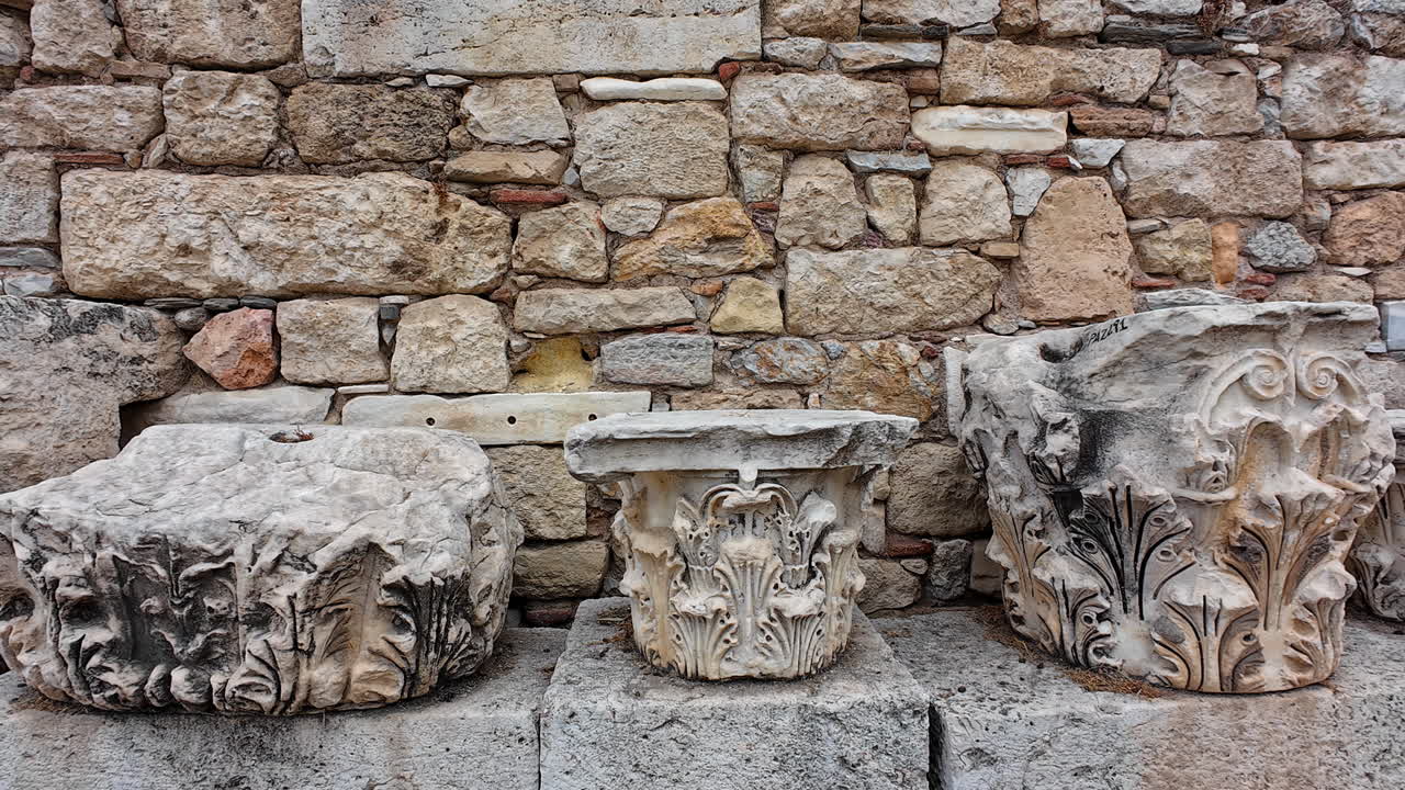 Panning shot of Rocks on the remains of the Roman Forum of Athens (Roman Agora) in Athens, Greece. Video reveals history.