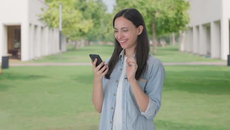 happy indian girl using phone