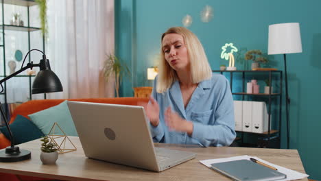 Upset-woman-with-hands-joined-at-web-camera-of-laptop-compute-asking-more-time-for-task-completion