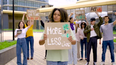 Young-Woman-Woman-On-Protest-Holding-More-Trees-Less-Lies-Placard