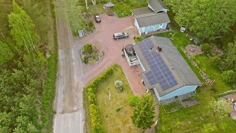 aerial view overlooking a renewable home with a a photovoltaic roof, summer day