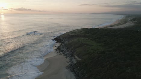 scenic-tropical-aerial-seascape-beach-footage-at-sunset-in-Puerto-escondido-mexico