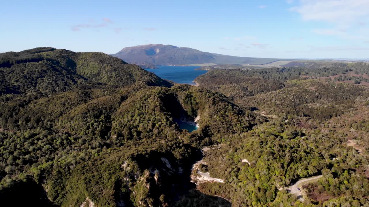 Waimangu Volcanic Valley aerial pull back shot tilt down to World's Largest Hot Spring