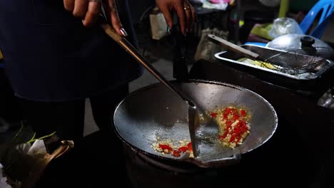 chef preparing food in a hot wok