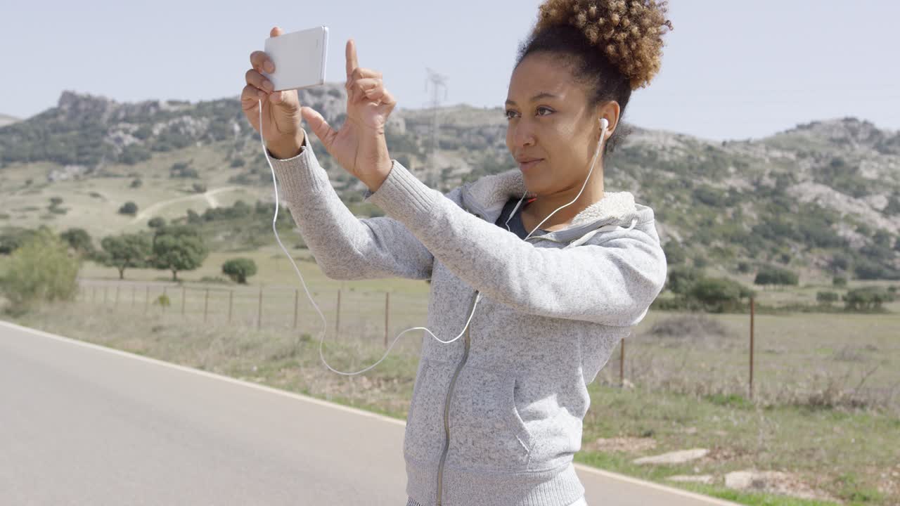 Young woman taking picture of nature
