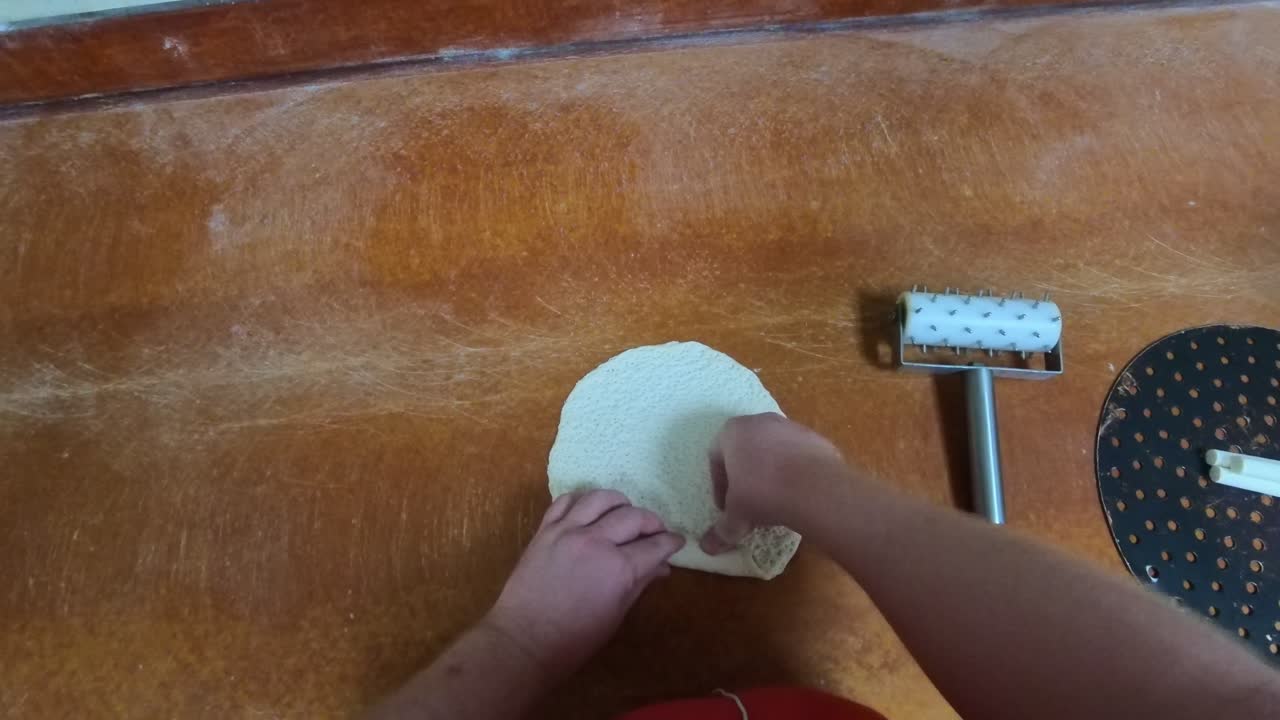 Pizza Commercial Kitchen POV rolling dough over cheese.