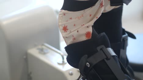 close-up of a leg with an orthopedic brace in a medical or rehabilitation setting