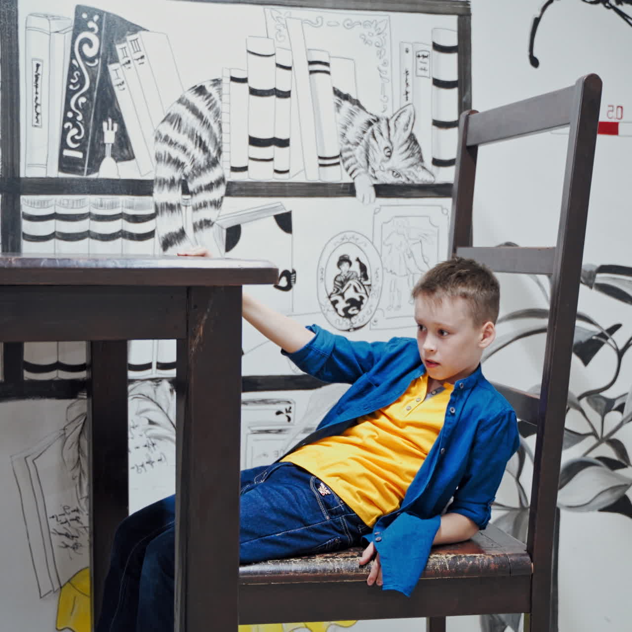 schoolboy makes practical experiments at a science centre. Science museum