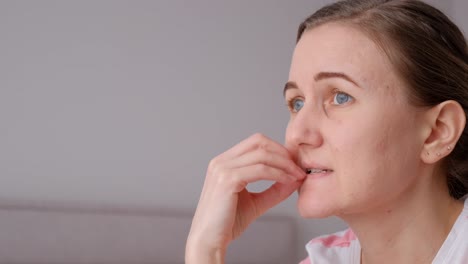 portrait of a caucasian nervous woman biting her nails with anxiety bottom view portrait of a caucasian nervous woman biting her nails with anxiety bottom view the concept of psychology and mental health