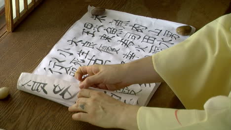 scroll of calligraphy is rolled up on japanese shoin desk