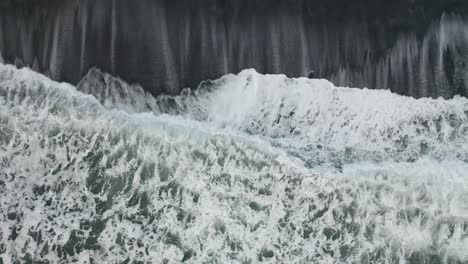 Drone-shot-of-waves-on-black-sand-beach-in-Iceland