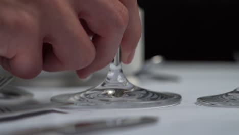 setting a table, close-up of placing a wine glass