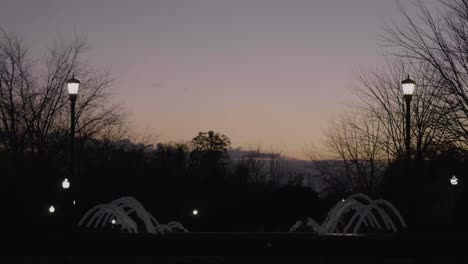 wide shot of a water fountain at sunset