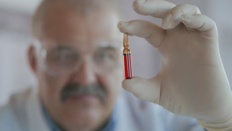 A-pharmacist-holds-a-medicine-in-ampoules-made-of-glass.-A-new-drug-to-fight-viruses-and-diseases.-Medicine-for-coronavirus.-High-quality-4k-footage