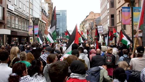pro palestine protesters march against israel’s eurovision participation in malmö (sweden), calling for a ceasefire on the war in gaza, eurovision song contest 2024, wide handheld shot