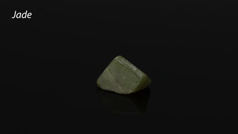 a jade stone rotating against a black background