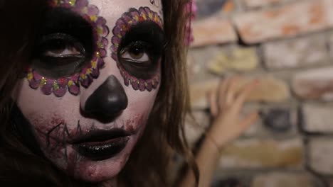 close-up of woman with day of the dead sugar skull makeup