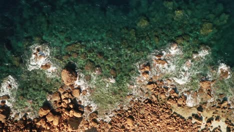 Aerial-high-angle-view-of-a-beautiful-turquoise-water-near-Rampla-Beach-on-the-Island-Gozo,-Malta